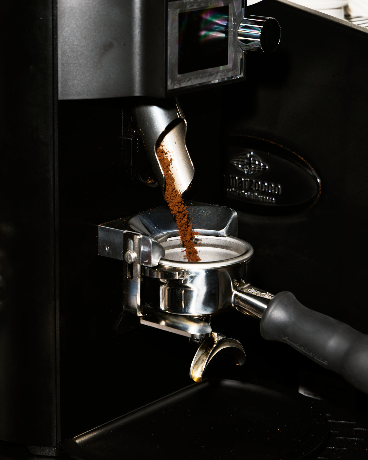 Fresh coffee grinding into a portafilter