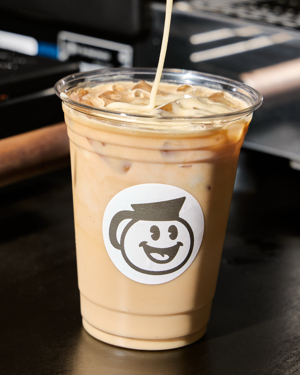 Iced latte with a sticker on the cup