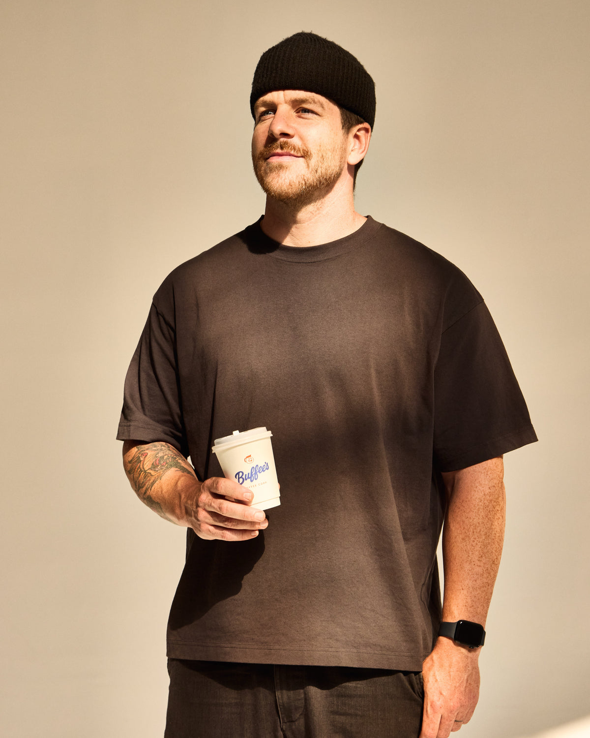 Will Robinson holding a Buffee's coffee in the sun